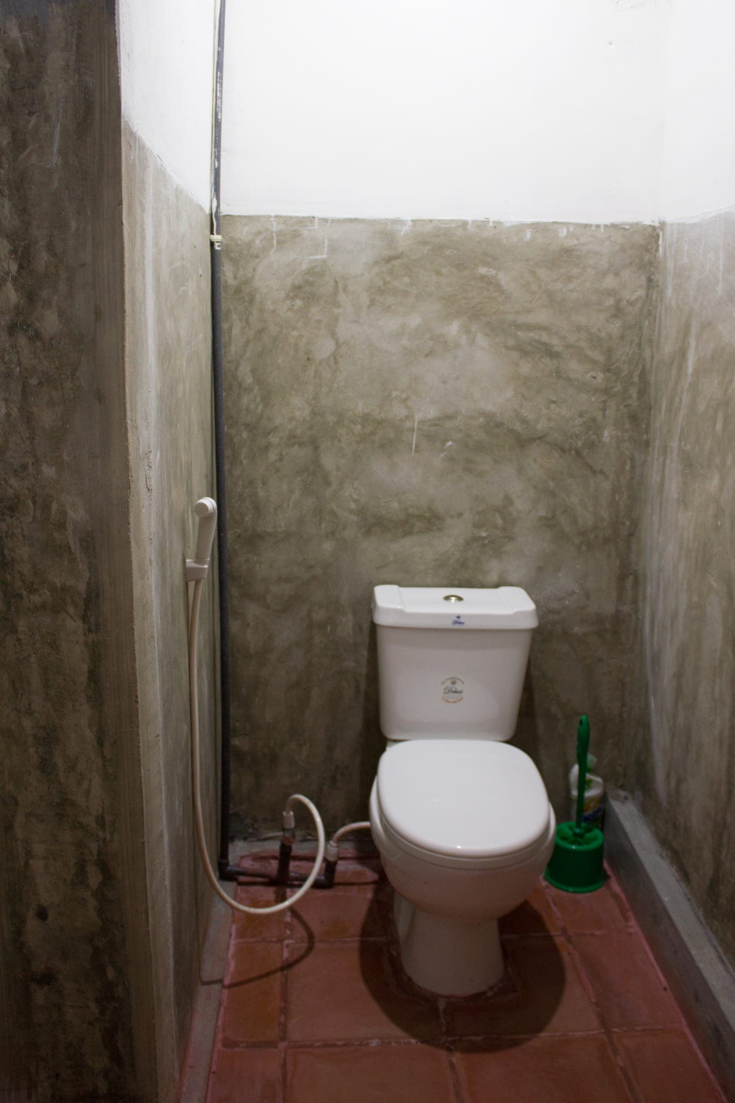 Bathroom with polished concrete walls and a solar-heated shower