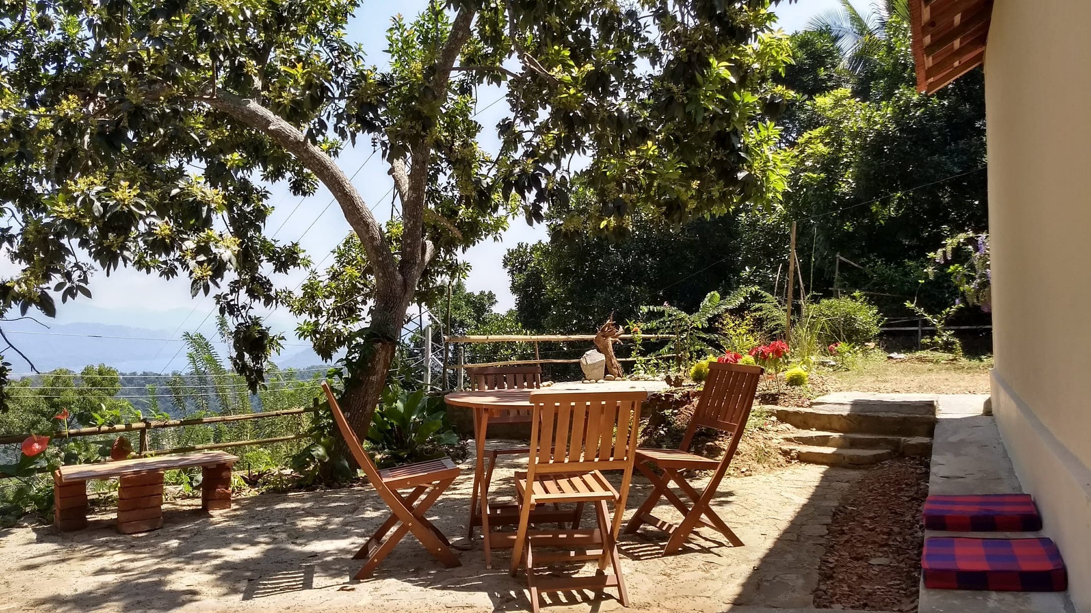 Outdoor dining set on the eastern terrace with the hills beyond