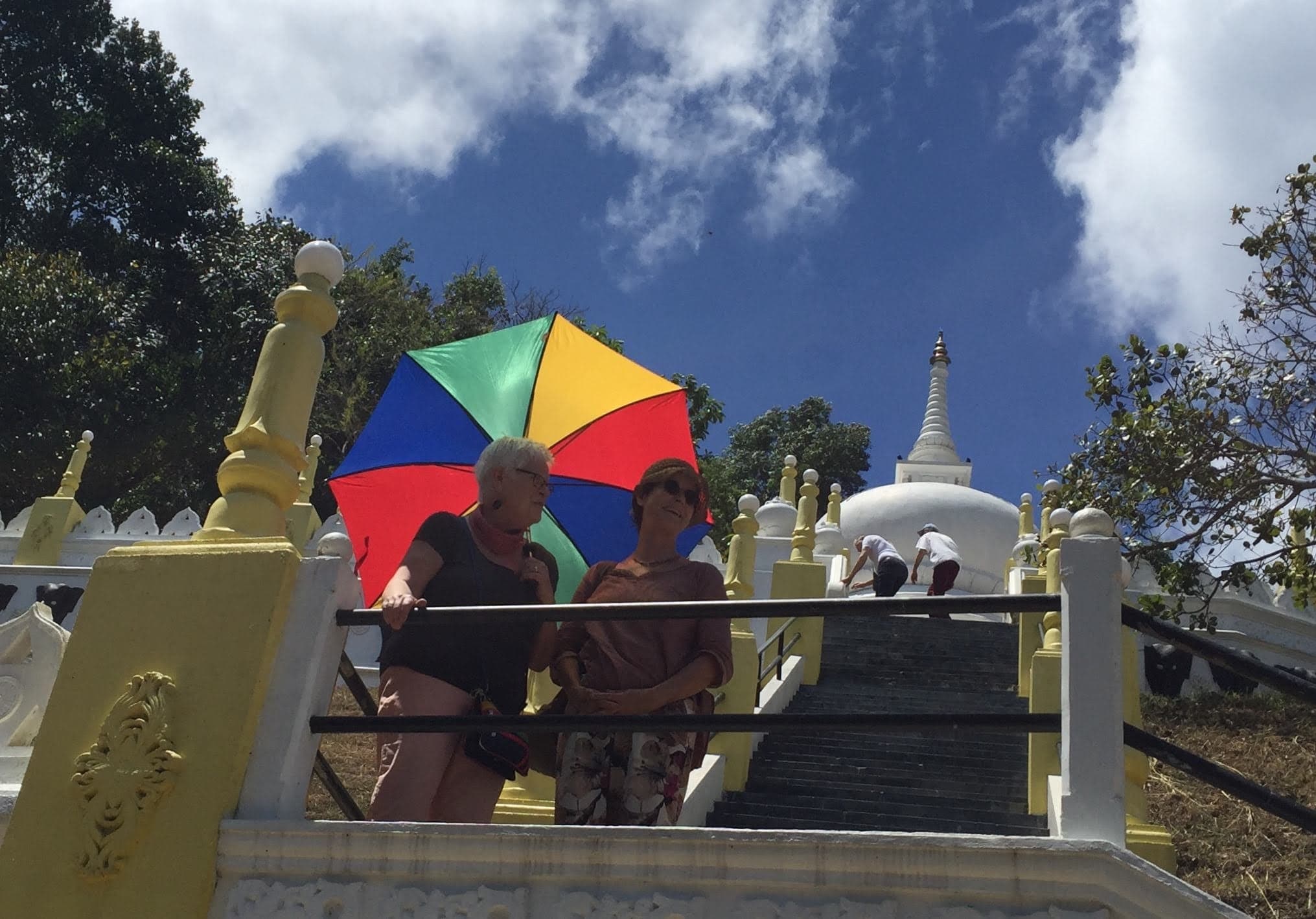 Visitors at a white stupa at a temple near the cottage
