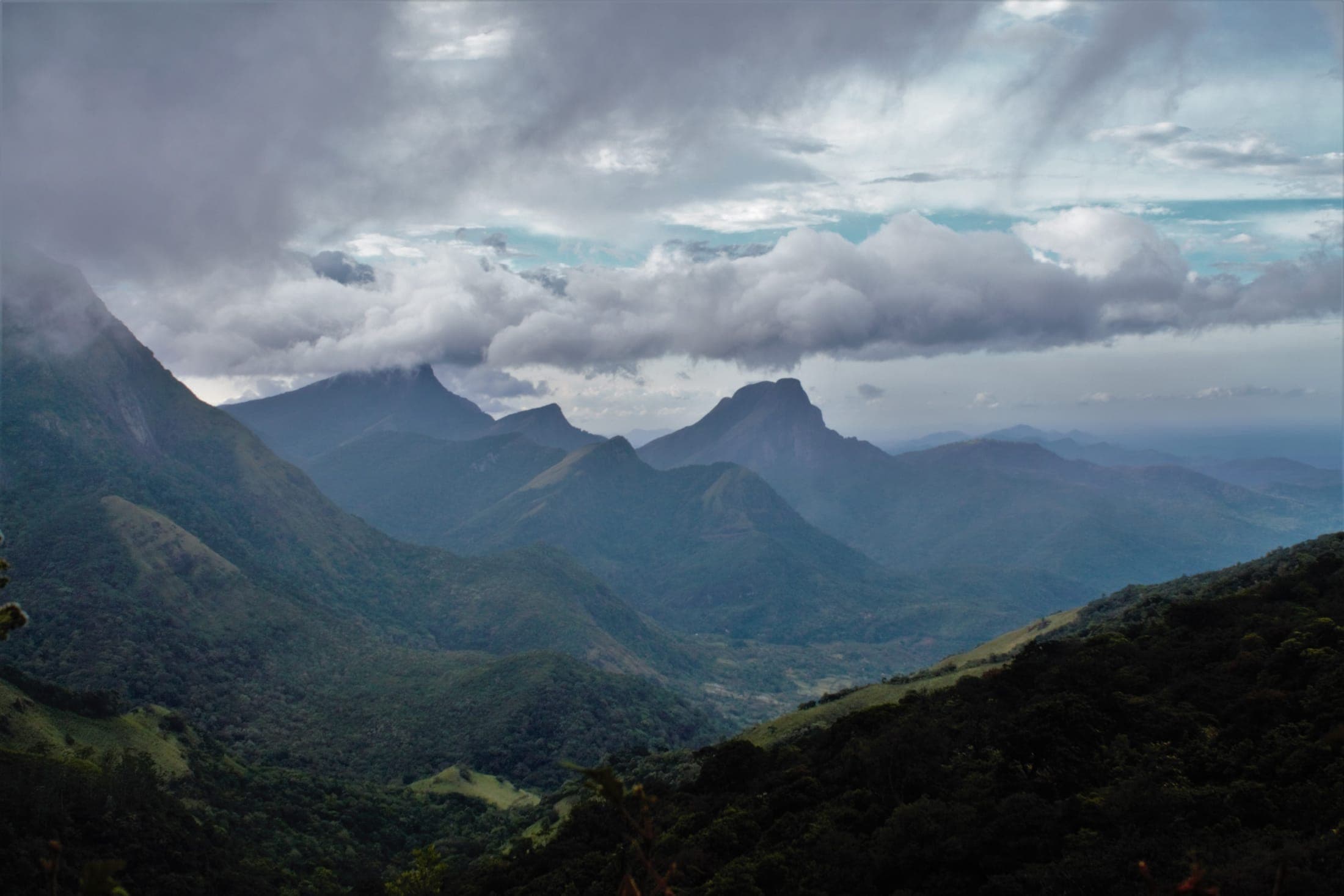 The jagged peaks of the Knuckles Mountain Range under dramatic clouds
