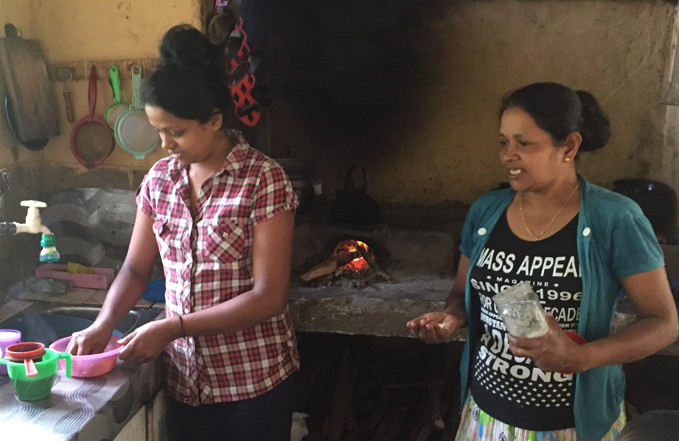 Neighbours cooking together in their village kitchen