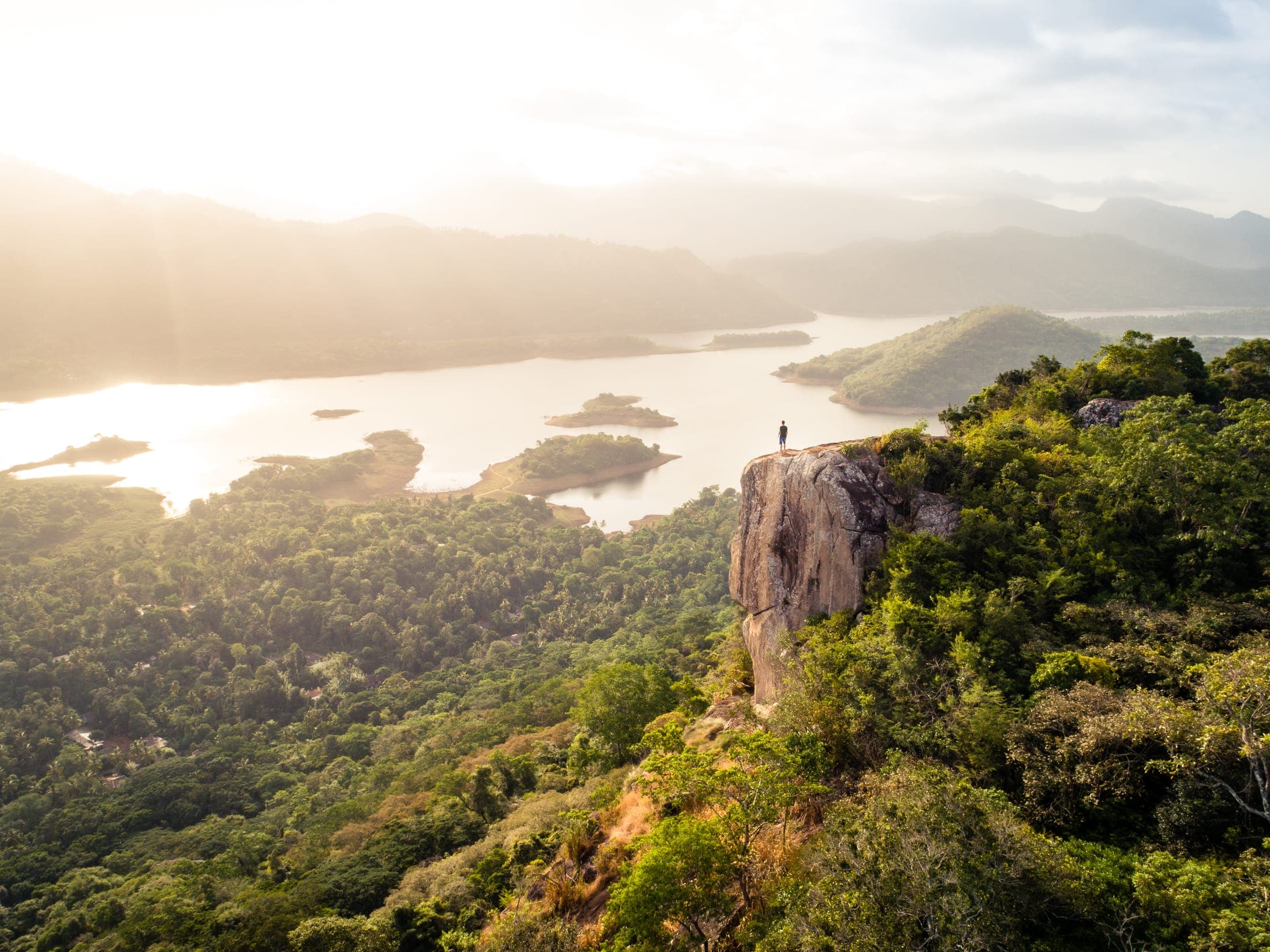 Aerial view at sunrise of Pettigala Rock above Victoria Lake and its forested islands